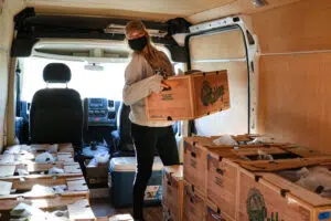 Staff loading CSA shares for delivery